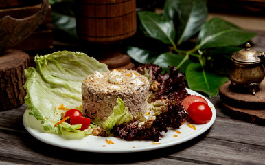chicken salad with walnut and mayonnaise served with lettuce leaves and tomato