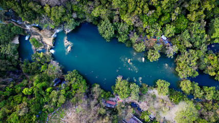 Beautiful Lake at San Luis Potosí in Huasteca Potosina, Mexico. Aerial drone photo of pond surrounded by forest full of green trees. - obrazy, fototapety, plakaty
