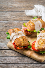 Fresh bread sandwich with ham, lettuce and tomato