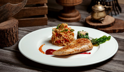 fried chicken breast with spaghetti and vegetables