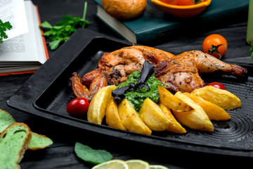fried chicken with potatoes on furnace board
