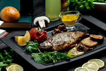 fried fish with vegetables in furnace