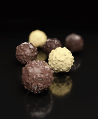Dark chocolate balls isolated on black background 3d rendering