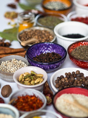 Various dry spices in small multi-colored bowls