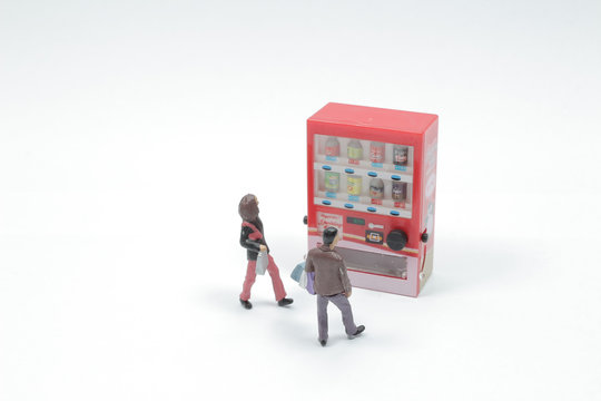 mini figure of Tourists are use drink coin machine at