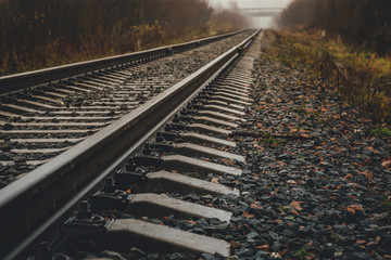 modern railway goes into foggy distance