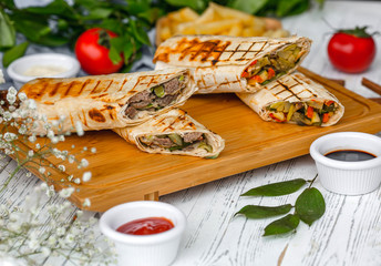 meat doner in lavash on wooden board