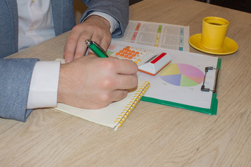 The Man are using a calculator on the table in the office room. accounting and business concept