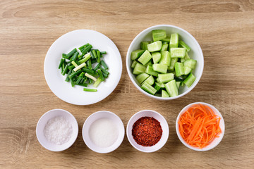 Kimchi cucumber cooking recipe on wooden table, homemade Korean food