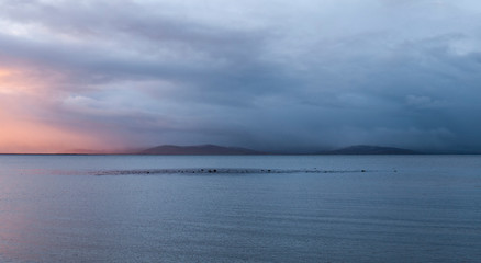 Galway Bay, Ireland at dawn with view across to the Burren. Taken from Salthill beach in the early morning at sunrise