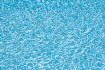 Fototapeta na wymiar Ripple wave with sun reflection in swimming pool