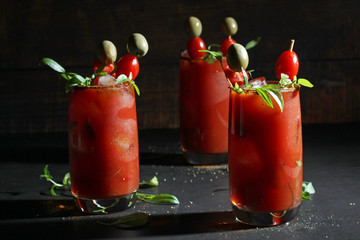 Three glasses with Bloody Mary cocktail	