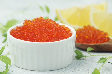 A small ceramic bowl with red caviar	