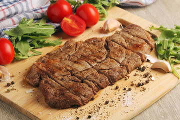 A beef steak well done with vegetables