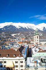 Fototapeta na wymiar Innsbruck in winter, Austria. Beautiful aerial panoramic view, mountains covered with snow in the background. 
