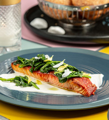 roasted salmon on cream garnished with sautéed spinach