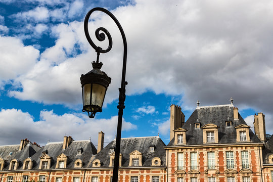 Close up on old buildings and street lamps of Place des Vosges during Autumn in Paris,The Place des Vosges  the oldest planned square in Paris, France.