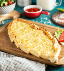 traditional turkish cheese pide on wooden board