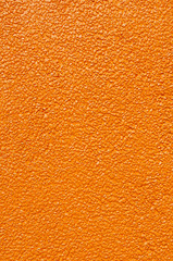 Surface of orange concrete mixed with gravel wall