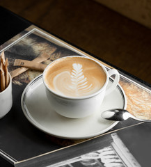 a cup of cappuccino with rosetta latte art