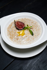Milk Hercules porridge on a wooden table. 