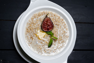 Milk Hercules porridge on a wooden table. 
