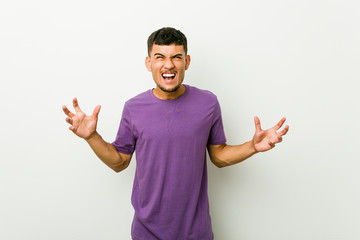 Fototapeta premium Young hispanic man screaming with rage.