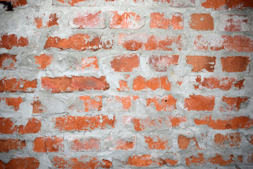 The structural wall is of red brick with uneven cement covered seams