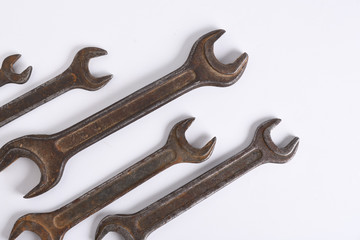 Old rusty stainless steel crescent wrench isolated on white top view
