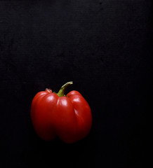 half of red bell pepper on a black background