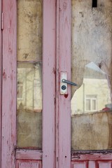 Old broken entrance purple door door close-up