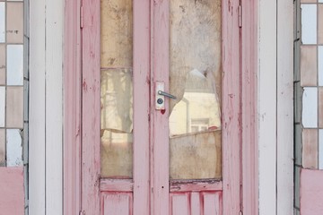 Old broken entrance purple door door close-up