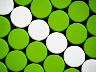  green and white plastic lid on a black background