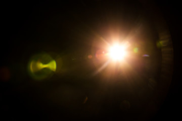 Abstract Natural Sun flare on the black background.
