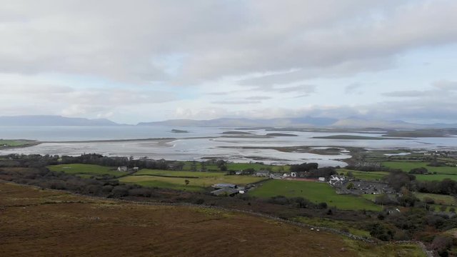 Aerial: Flying backwards above landscape of Clew Bay with many islands, Ireland