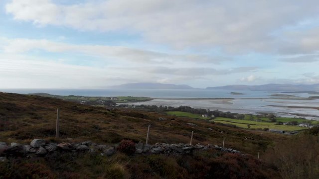 Aerial: Flying above ground on Croagh Patrick and famous Clew Bay in Ireland