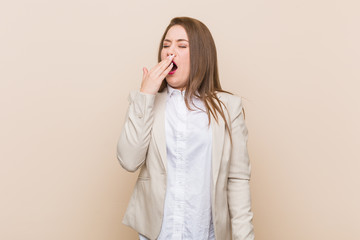 Young business woman yawning showing a tired gesture covering mouth with hand.