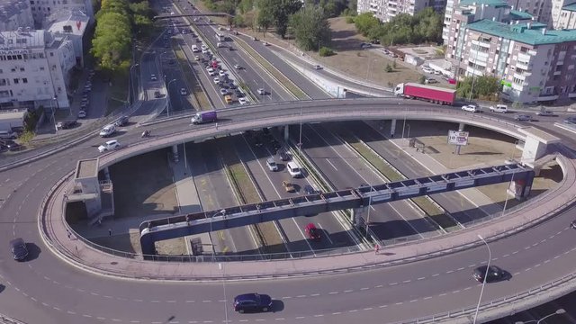 Slow tilting establishing shot of roundabout and highway near Genex tower