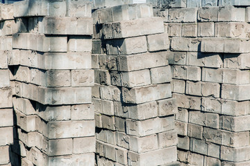 Old concrete bricks stacked in a row. Paving tiles background
