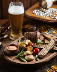 wood platter of beef steak with grilled aubergine, potato, mushroom and sauce