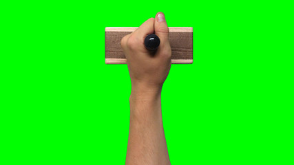Hand Holding Large Stamp on Chroma Key Green Background	