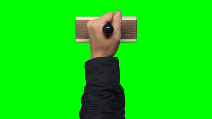 Hand Black Sleeve Holding Large Stamp on Chroma Key Green Background	