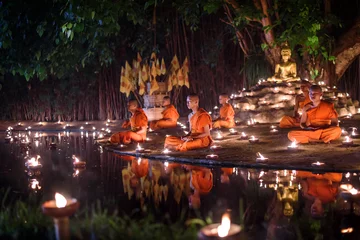 Fotobehang Boeddha CHIANG MAI, THAILAND - May 18:  Visakha Puja Day Thai monks sitting meditate with many candle at Phan Tao temple  on May 18, 2019 in Chiang Mai, Thailand.  © jaboo_foto