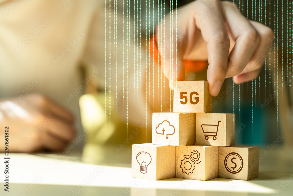 Poster businessman hand arranging wood block stacking with icon 5g network digital hologram and iot(interne