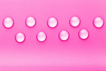 Drops of water on a color background. Pink. Toned