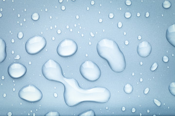 Drops of water on a color background. Blue. Toned