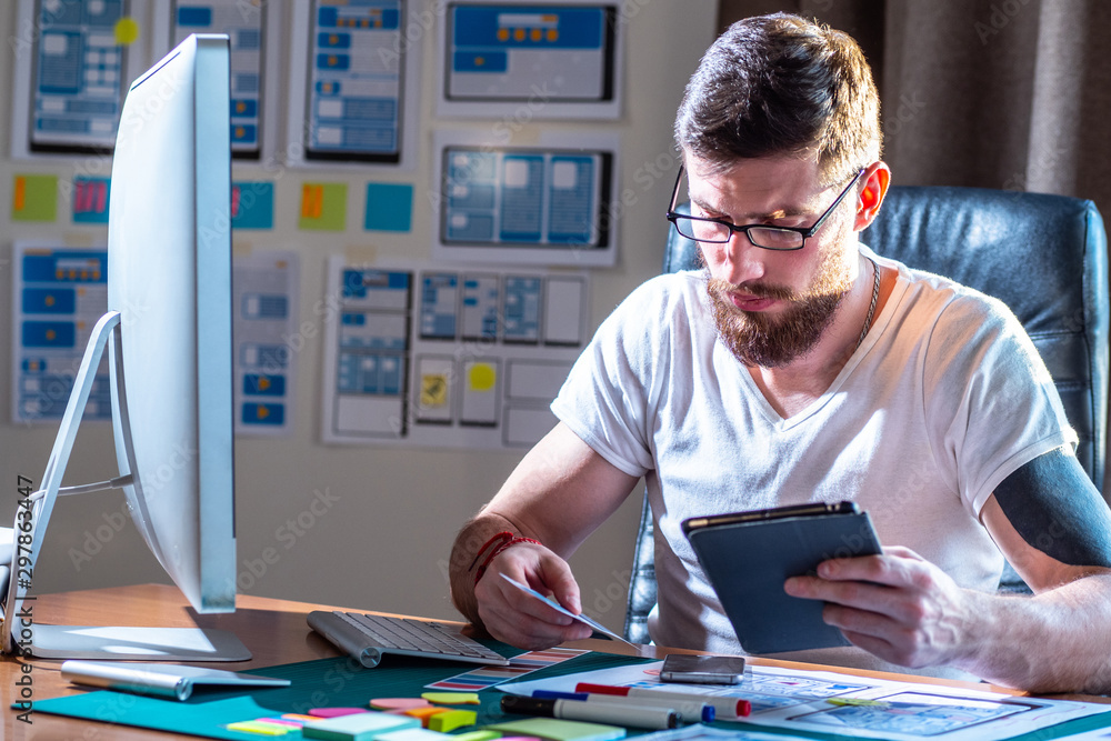 Poster man at the computer. human behind the working steel. concept - office worker. man with a beard. free
