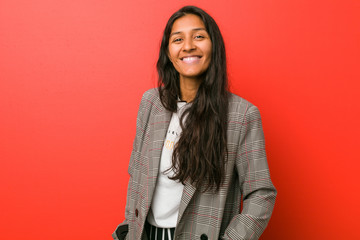 Young indian woman against a red background