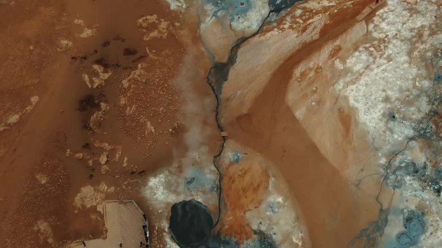 Aerial top down view of boiling mud pits and fumaroles in Hverir, Iceland