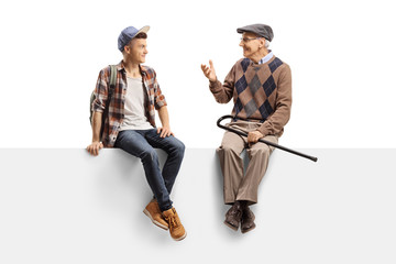 Young guy sitting on a panel and listening to his grandfather